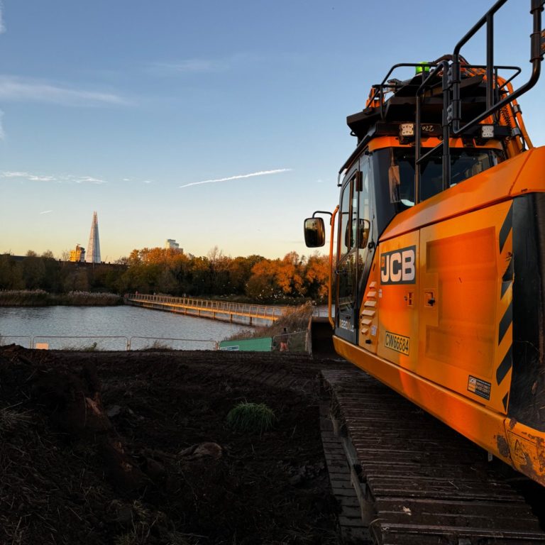 Bulk earthmoving and plant operations Excavator carrying out bulk earthmoving and ground regrading works on a live construction site using digger hire